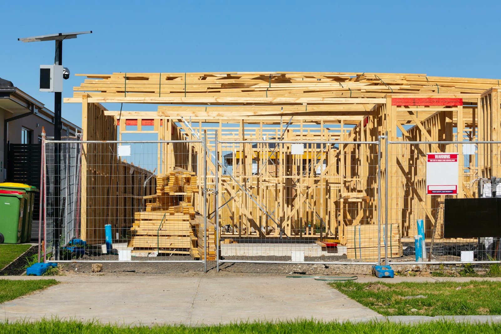Placeholder photograph of a timber-framed house under construction