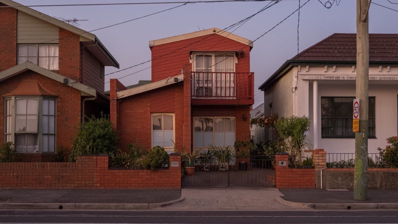 A pair of brick houses with pitched roofs