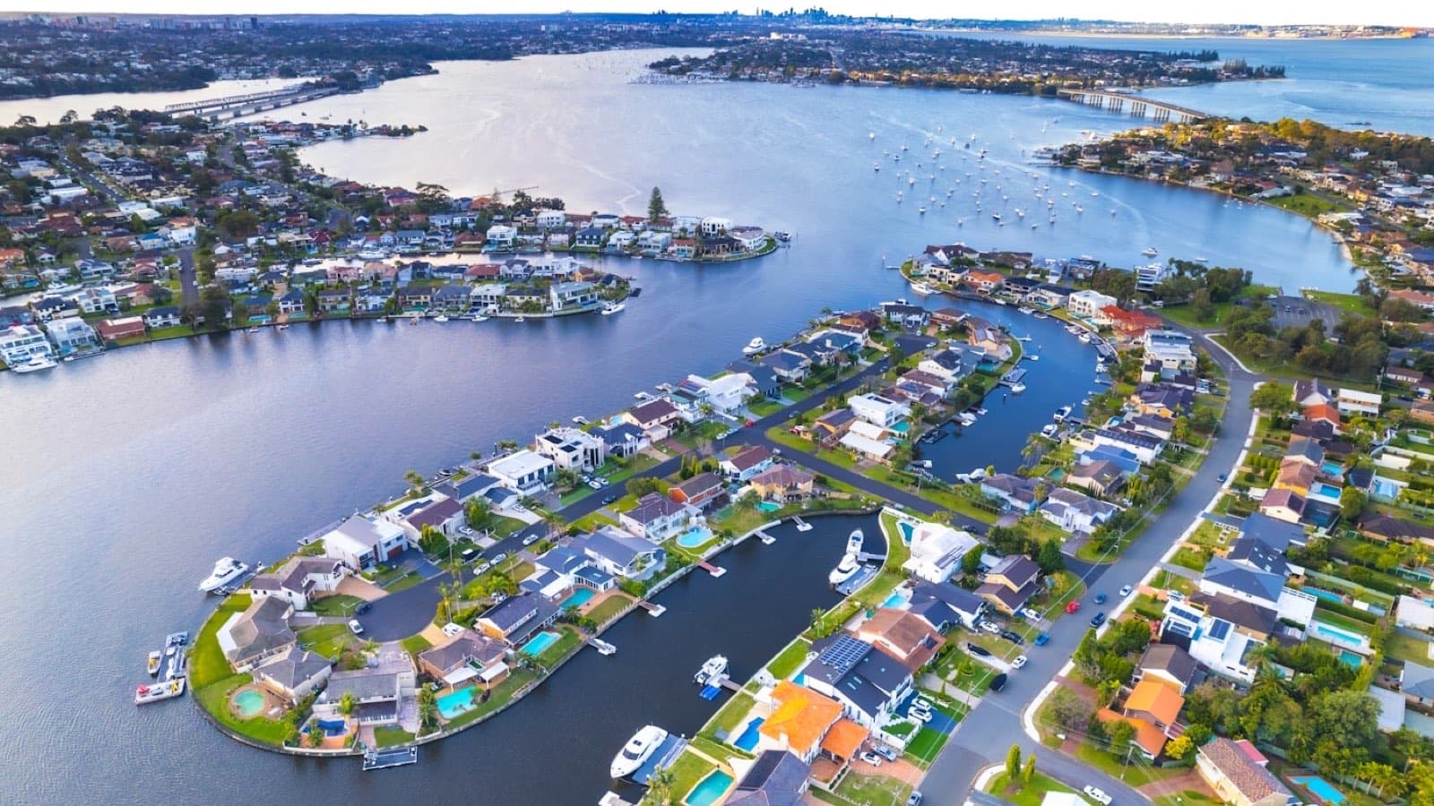 Aerial view of waterfront housing beside an inlet